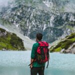 man standing on lakeside