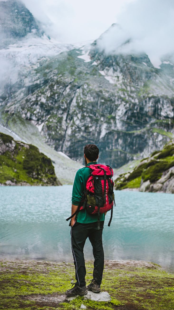 man standing on lakeside